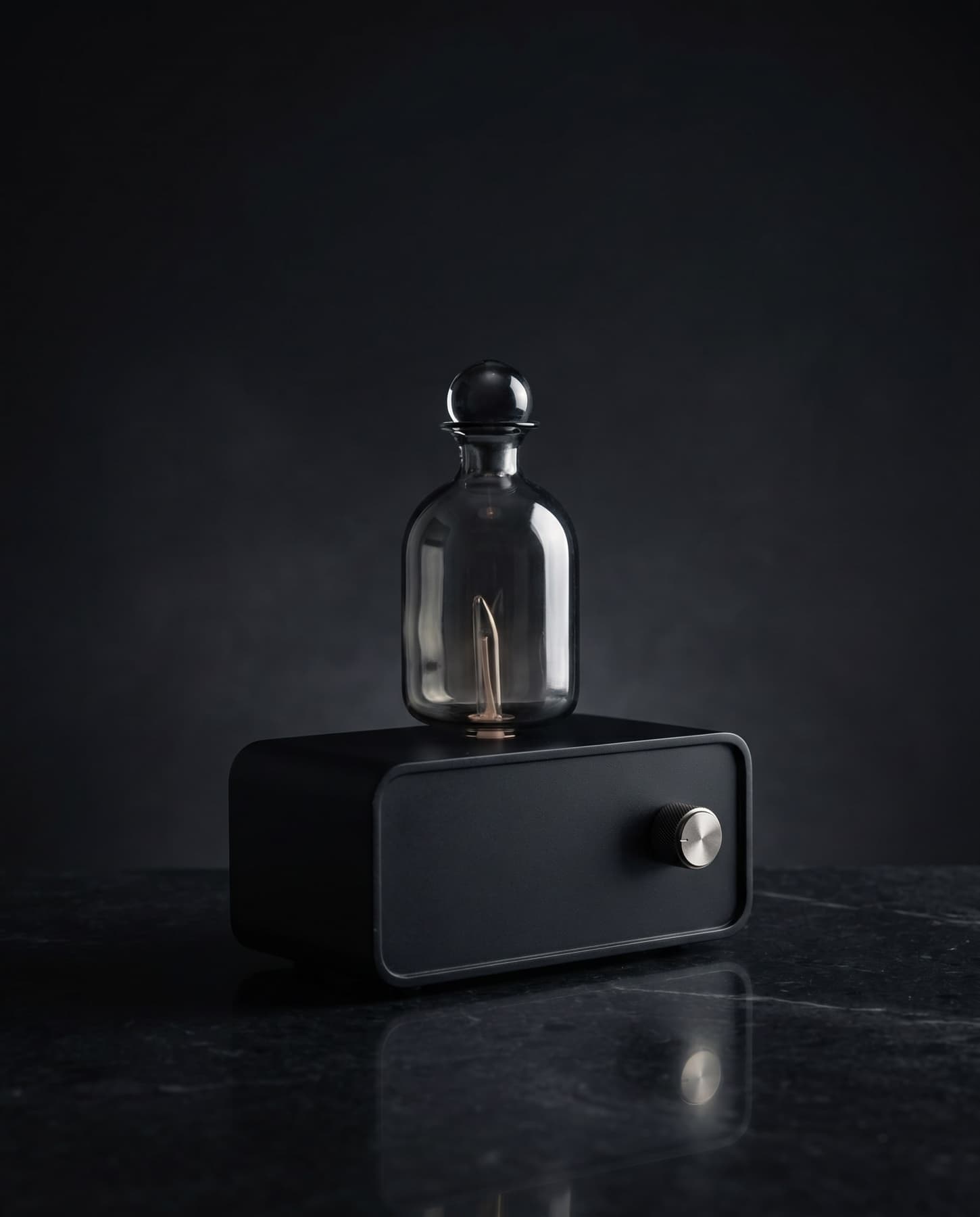The Still pure oil diffuser on a dark marble surface